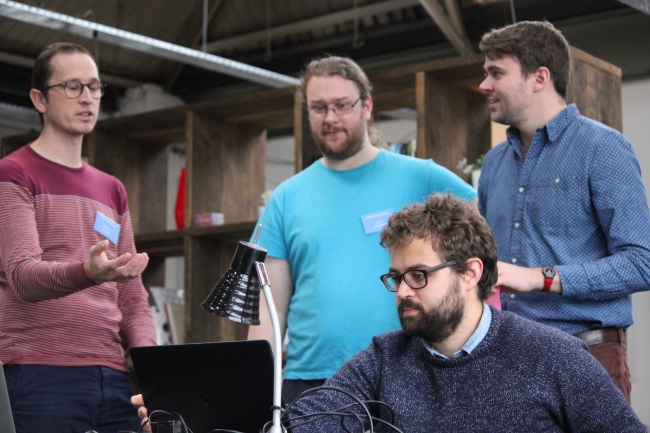 group of developers around a laptop