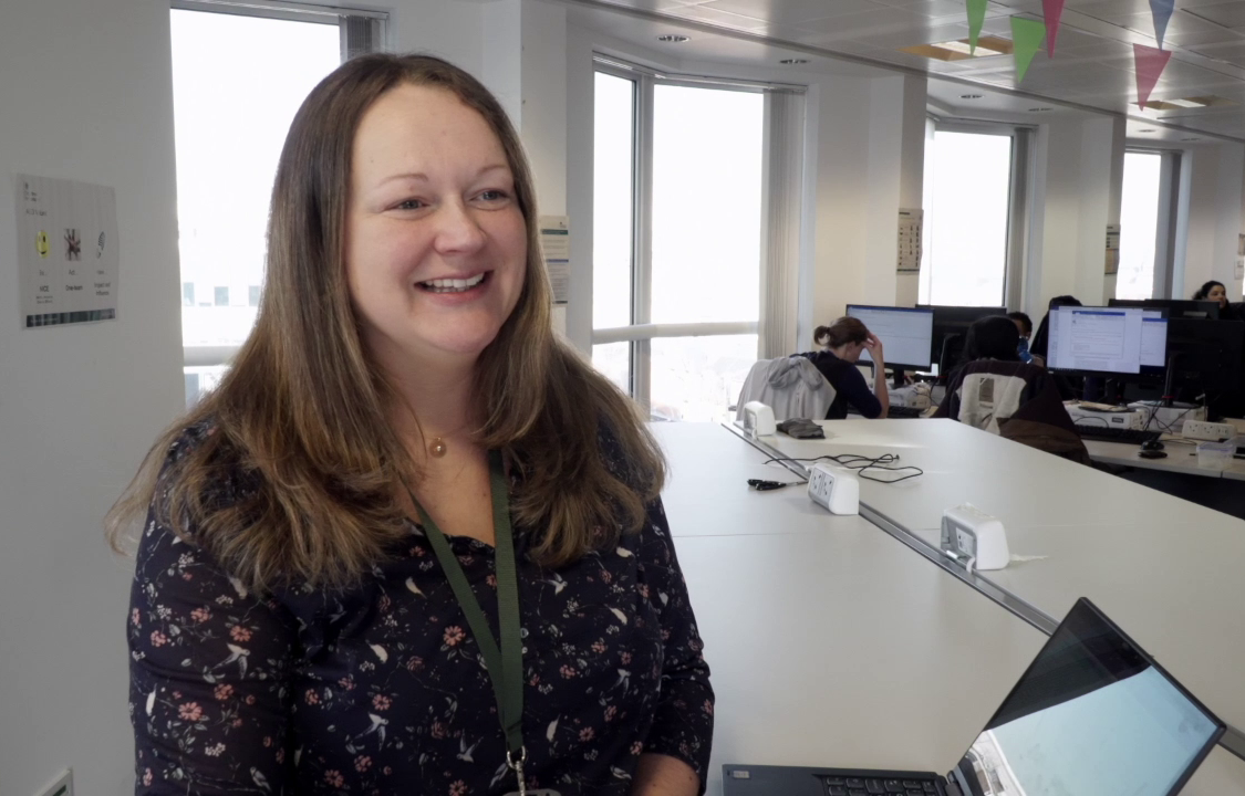 Jo at work, speaking to someone off camera